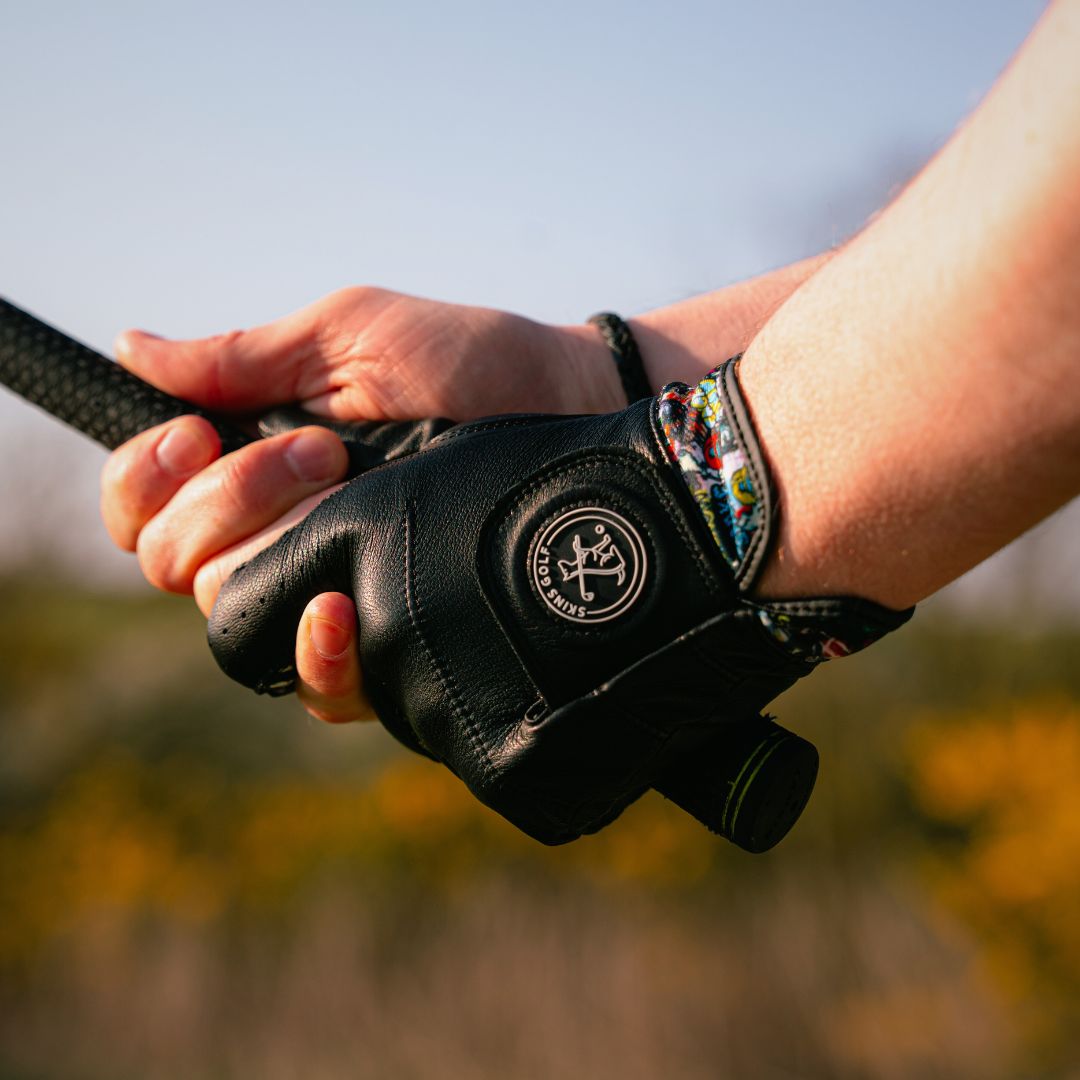 black leather golf glove holding a club