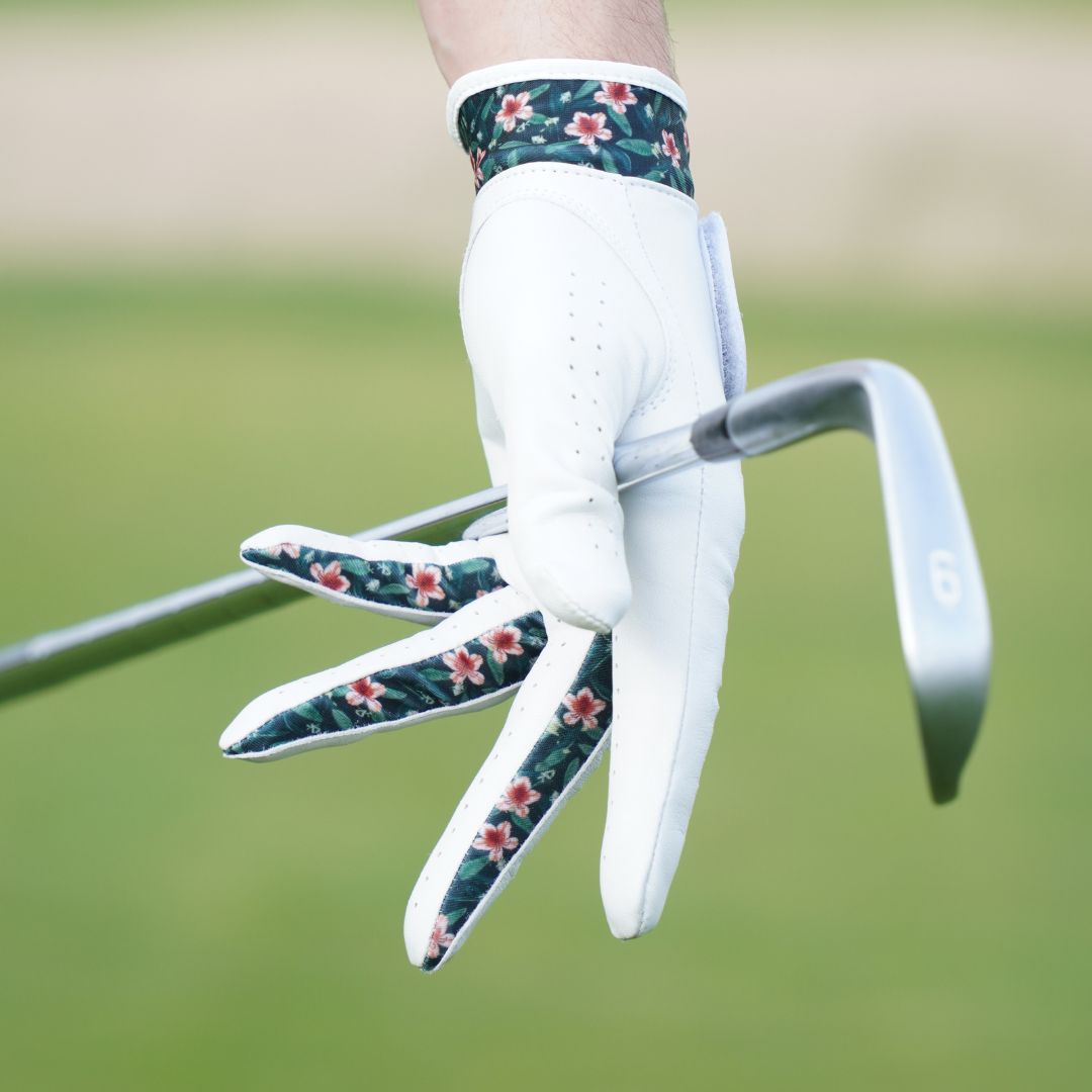 Golf glove with floral pattern on a blurred green background