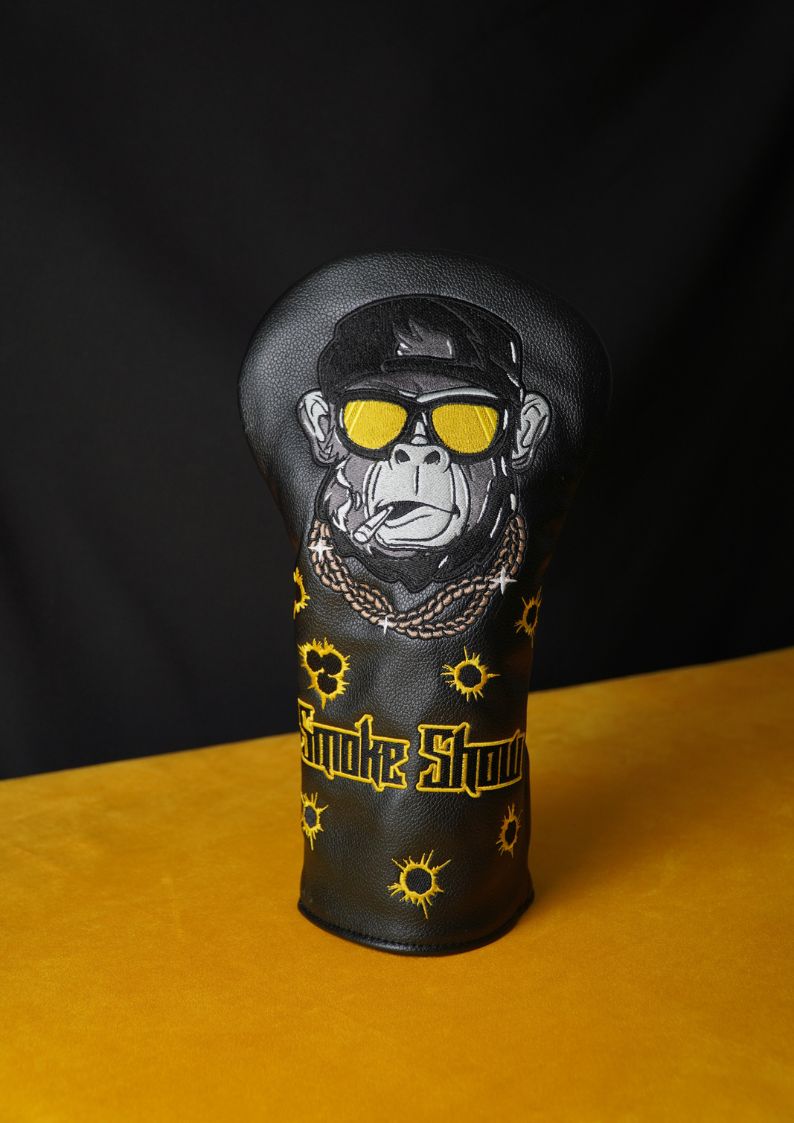 Golf club head cover with monkey design and text on a black background