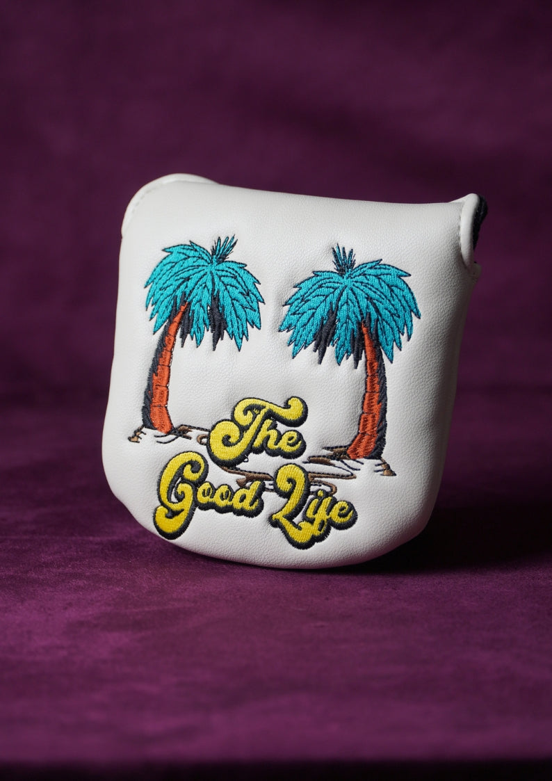 White golf headcover with palm tree design and 'The Good Life' text on a purple background