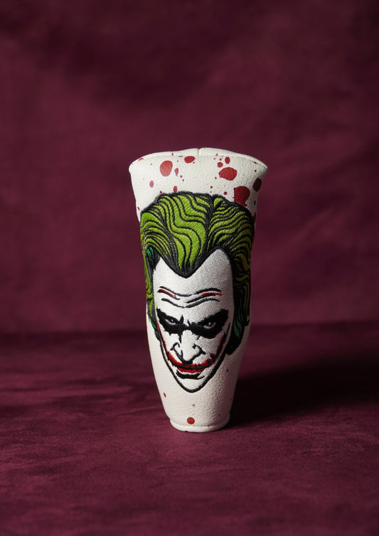 Blade headcover with a Joker design on a maroon background