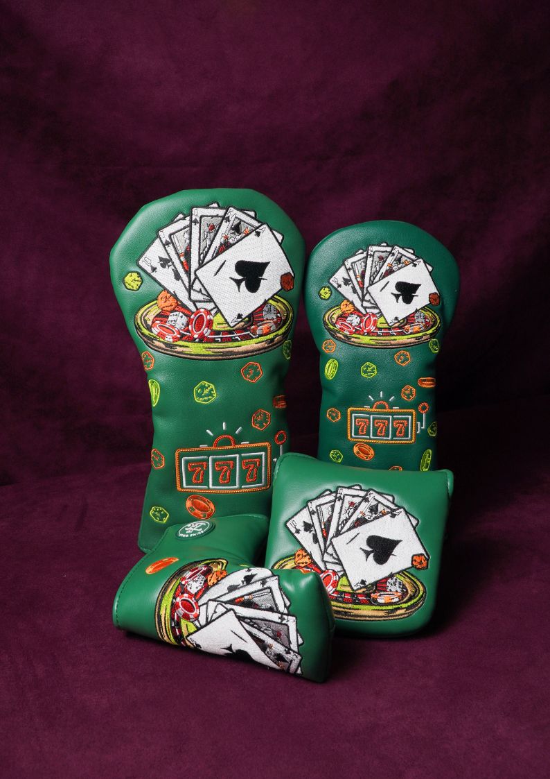 Decorative green headcovers with playing card designs on a purple background