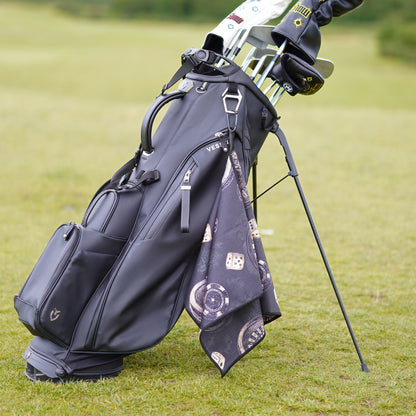 Golf bag with golf clubs on a grassy field