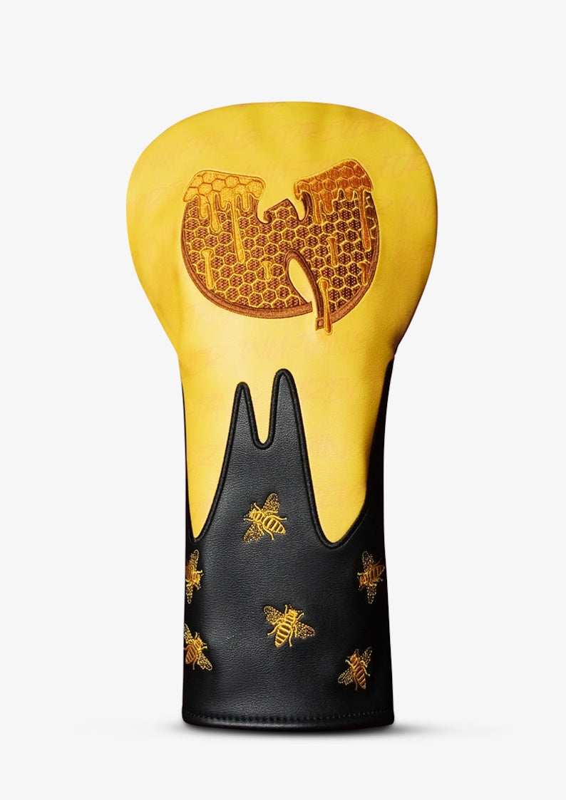 A golf club headcover featuring a yellow and black dripping design inspired by the Wu-Tang Clan logo, decorated with gold honeycomb patterns, a large honeycomb 'W' on the yellow section, and gold bees on the black section.