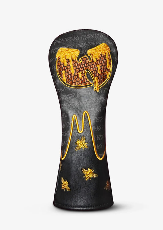 A black golf club headcover featuring a gold honeycomb and bee design, with a dripping honey graphic on the top, set against a light gray background.