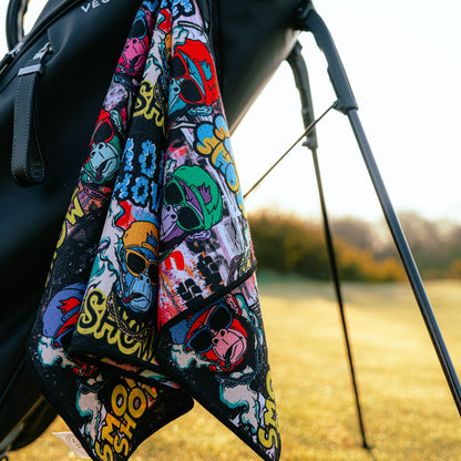 cool golf towel laying on a bag